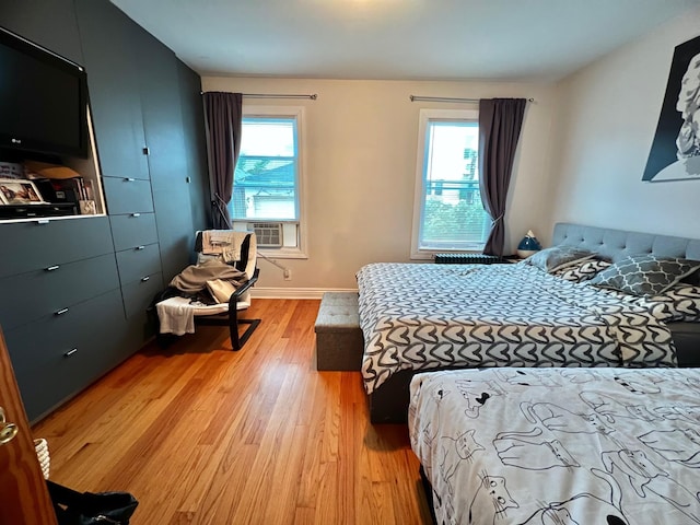 75-09 60th Pl, Glendale, NY 11385 - bedroom featuring light wood-type flooring, cooling unit, and baseboards