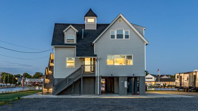 200LOTA Clocks Blvd, Massapequa, NY 11758 - back of property with stairs and roof with shingles