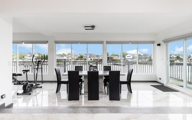 200LOTA Clocks Blvd, Massapequa, NY 11758 - dining room featuring marble tiled flooring, plenty of natural light, baseboards, and a water view