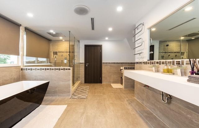 200LOTA Clocks Blvd, Massapequa, NY 11758 - full bath featuring tile walls, a stall shower, a freestanding tub, recessed lighting, and tile patterned floors
