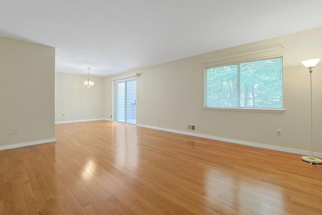 165 Carriage Ct Unit H, Yorktown Heights, NY 10598 - empty room featuring a chandelier and light wood finished floors