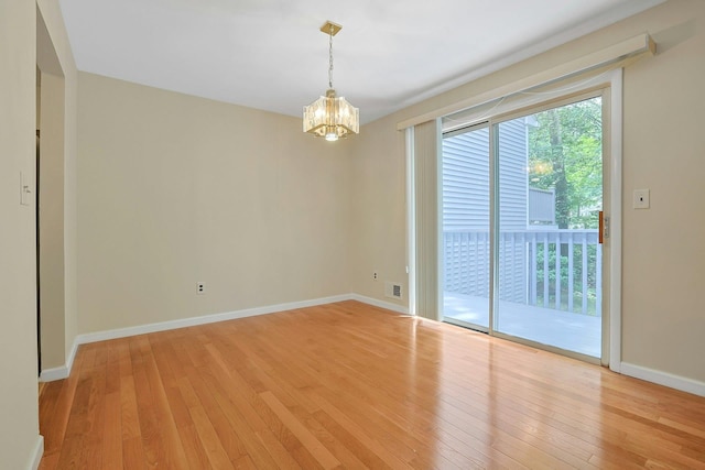 165 Carriage Ct Unit H, Yorktown Heights, NY 10598 - spare room with light wood-style flooring and a chandelier