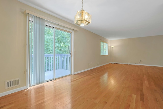 165 Carriage Ct Unit H, Yorktown Heights, NY 10598 - spare room with a chandelier and light wood-type flooring