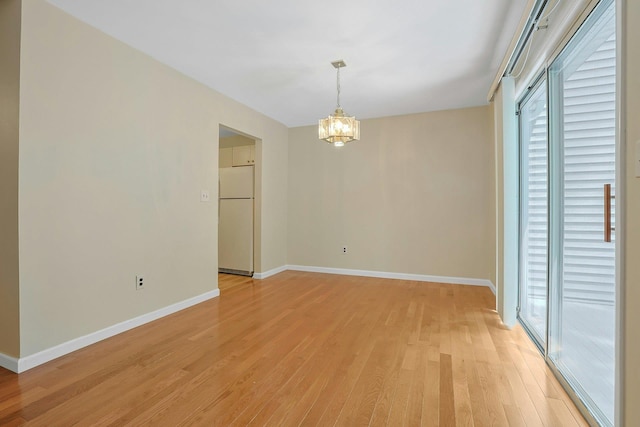 165 Carriage Ct Unit H, Yorktown Heights, NY 10598 - unfurnished dining area featuring a chandelier, healthy amount of natural light, and light wood finished floors