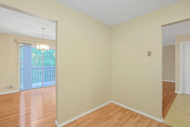 165 Carriage Ct Unit H, Yorktown Heights, NY 10598 - spare room featuring light wood-style flooring and a chandelier