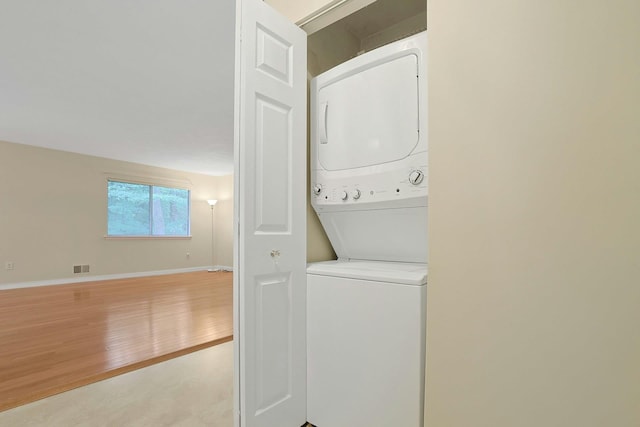 165 Carriage Ct Unit H, Yorktown Heights, NY 10598 - laundry room with stacked washer / dryer and light wood-style floors
