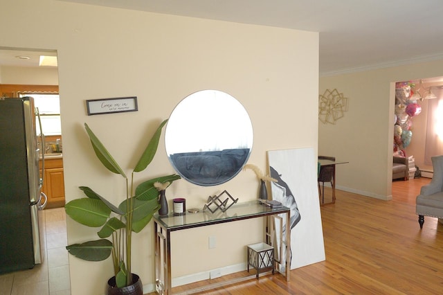 238 Adams St, Deer Park, NY 11729 - corridor featuring light wood-type flooring, crown molding, and a baseboard heating unit