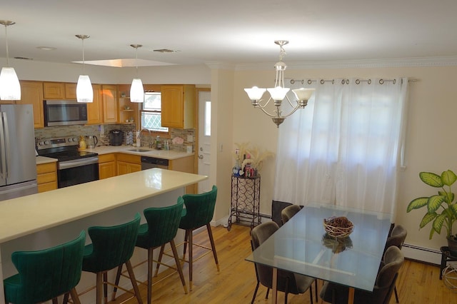 238 Adams St, Deer Park, NY 11729 - kitchen with appliances with stainless steel finishes, decorative backsplash, light countertops, a baseboard heating unit, and a chandelier