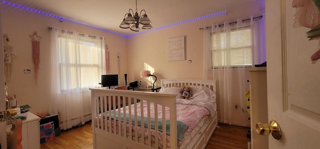 238 Adams St, Deer Park, NY 11729 - bedroom with wood finished floors, a chandelier, and a baseboard radiator