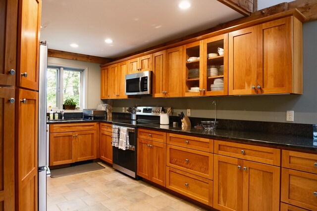 1900 Home, Sheffield, MA 01230 - kitchen featuring appliances with stainless steel finishes, brown cabinets, recessed lighting, glass insert cabinets, and dark stone counters