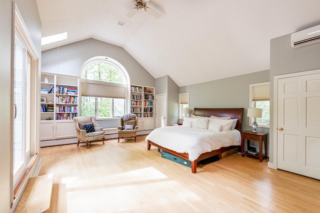 1900 Home, Sheffield, MA 01230 - bedroom featuring vaulted ceiling, a skylight, wood finished floors, a wall unit AC, and a ceiling fan