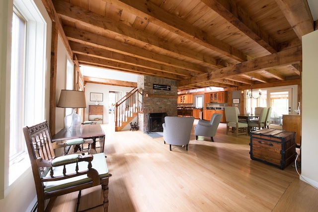 1900 Home, Sheffield, MA 01230 - living room featuring light wood-type flooring, wood ceiling with exposed beams, a brick fireplace, a chandelier, and stairs