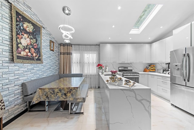 32 Henry Pl, Staten Island, NY 10305 - kitchen with appliances with stainless steel finishes, modern cabinets, white cabinets, a chandelier, and decorative light fixtures