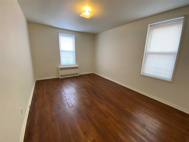 501 Riverdale Ave Unit 6L, Yonkers, NY 10705 - spare room with radiator, dark wood-type flooring, and baseboards