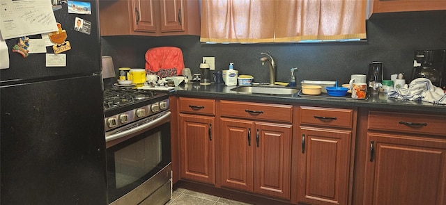 16023 28th Ave, Flushing, NY 11358 - kitchen featuring freestanding refrigerator, stainless steel gas stove, a sink, light tile patterned flooring, and dark countertops