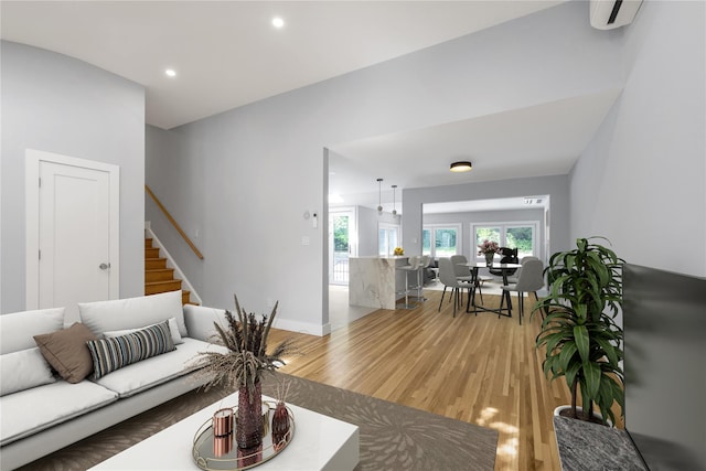 27 Meadowfield Ln, Glen Cove, NY 11542 - living area with light wood-style flooring, stairway, recessed lighting, a wall mounted AC, and baseboards