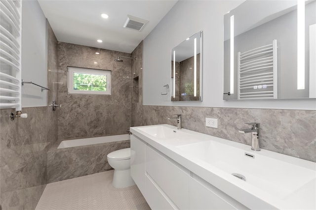 27 Meadowfield Ln, Glen Cove, NY 11542 - bathroom featuring radiator heating unit, a combined bath / shower with marble appearance, tile walls, a towel warming rack, and toilet