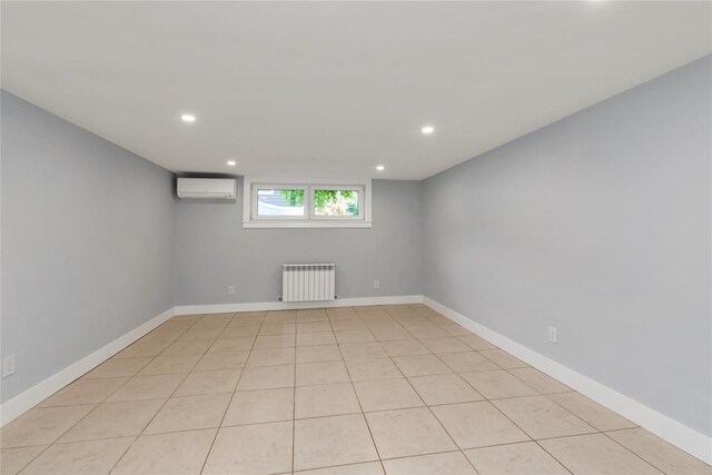 27 Meadowfield Ln, Glen Cove, NY 11542 - basement with radiator, recessed lighting, a wall mounted AC, and baseboards