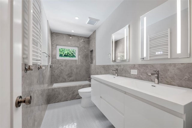27 Meadowfield Ln, Glen Cove, NY 11542 - bathroom with radiator heating unit, a combined bath / shower with marble appearance, a towel warmer, double vanity, and tile walls