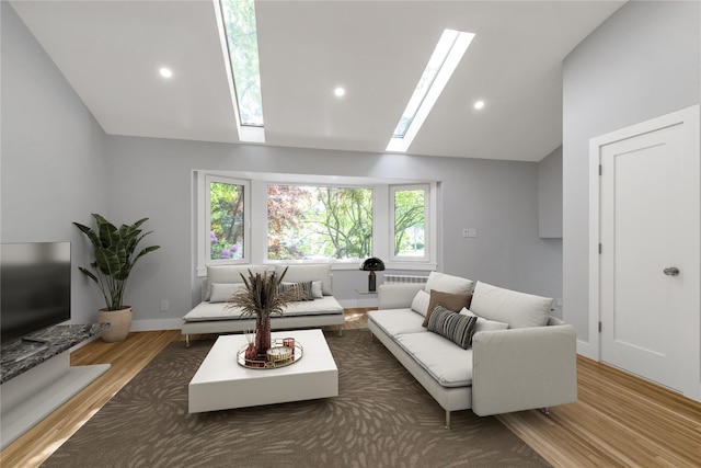 27 Meadowfield Ln, Glen Cove, NY 11542 - living room with a skylight, lofted ceiling, wood finished floors, and recessed lighting