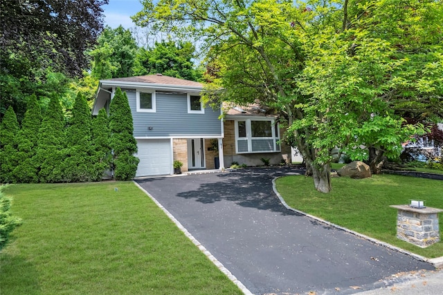 27 Meadowfield Ln, Glen Cove, NY 11542 - tri-level home with driveway, a garage, and a front yard