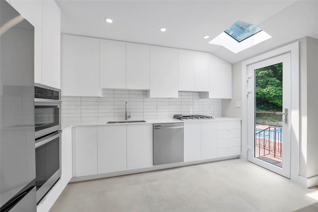 27 Meadowfield Ln, Glen Cove, NY 11542 - kitchen featuring stainless steel appliances, a skylight, modern cabinets, light countertops, and recessed lighting