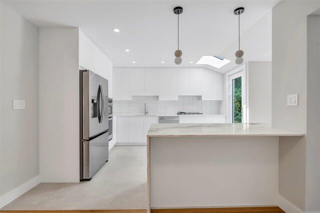 27 Meadowfield Ln, Glen Cove, NY 11542 - kitchen featuring stainless steel appliances, modern cabinets, white cabinets, a peninsula, and recessed lighting
