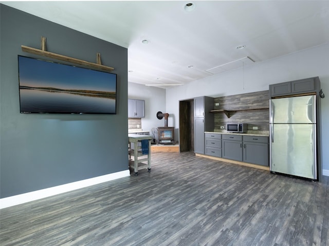 123 Wildwood Way, Forestburgh, NY 12777 - living room with attic access, dark wood-style floors, a wood stove, baseboards, and recessed lighting