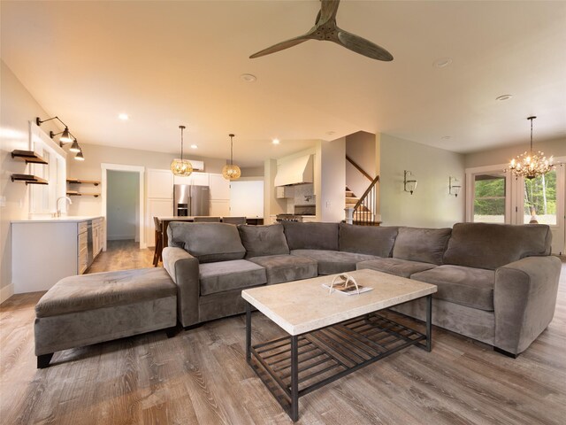 123 Wildwood Way, Forestburgh, NY 12777 - living area featuring wood finished floors, stairway, a ceiling fan, a chandelier, and recessed lighting