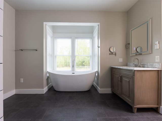 123 Wildwood Way, Forestburgh, NY 12777 - full bathroom featuring baseboards, vanity, a freestanding tub, and tile patterned floors