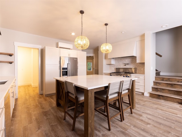 123 Wildwood Way, Forestburgh, NY 12777 - kitchen featuring high end refrigerator, a wall unit AC, backsplash, light countertops, and light wood finished floors