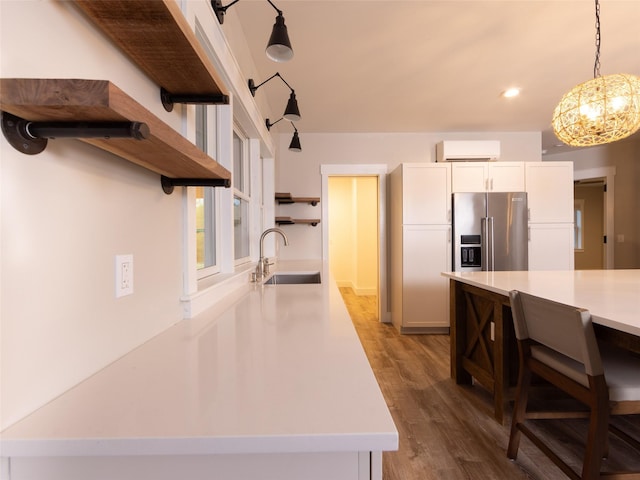 123 Wildwood Way, Forestburgh, NY 12777 - kitchen with open shelves, a sink, high end fridge, a wall mounted AC, and light countertops
