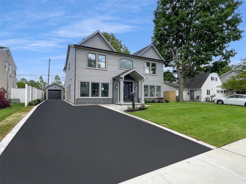 229 Blueberry Ln, Hicksville, NY 11801 - view of front of property featuring a garage, an outbuilding, asphalt driveway, and stucco siding