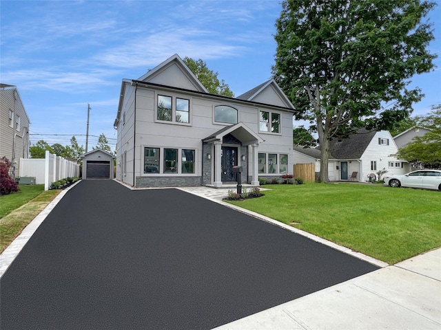 229 Blueberry Ln, Hicksville, NY 11801 - view of front of property featuring a garage, an outbuilding, asphalt driveway, and stucco siding