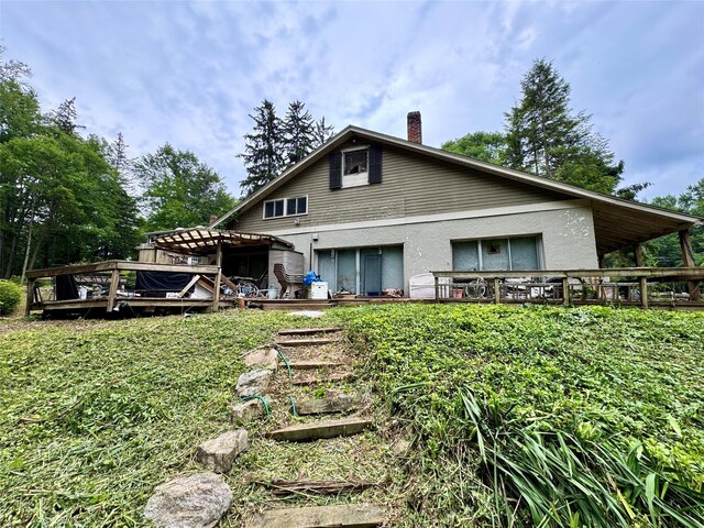 210A Seven Bridges Rd, Mount Kisco, NY 10549 - back of property featuring a deck, a chimney, and stucco siding