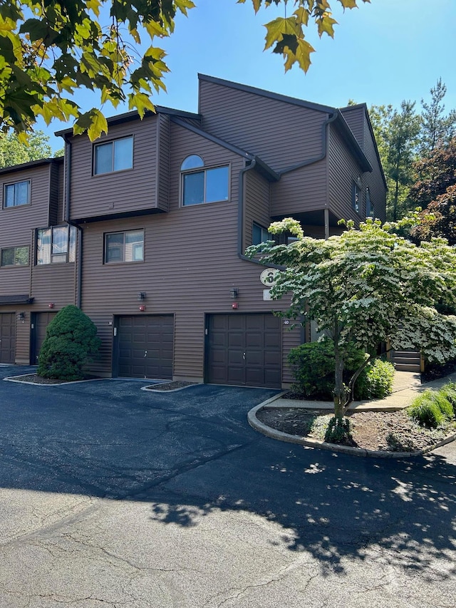 38 Tulip Ct, Nanuet, NY 10954 - view of side of home featuring an attached garage and driveway