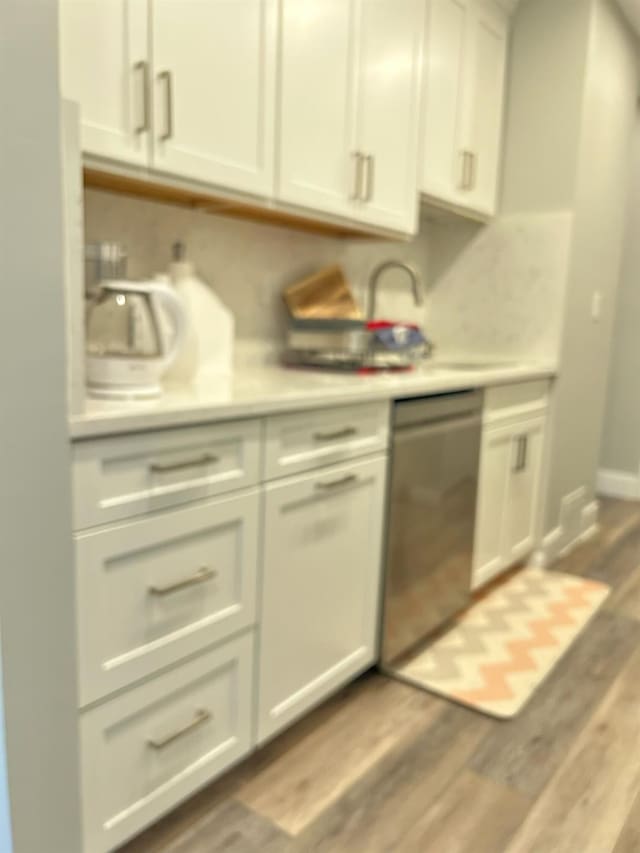 38 Tulip Ct, Nanuet, NY 10954 - kitchen featuring dishwasher, light countertops, wood finished floors, baseboards, and white cabinets