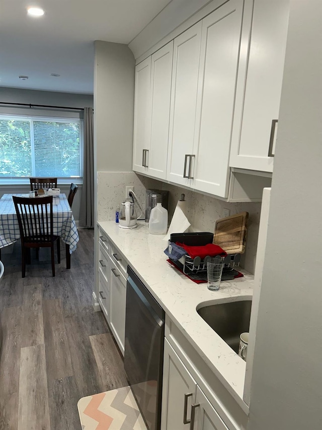 38 Tulip Ct, Nanuet, NY 10954 - kitchen with stainless steel dishwasher, dark wood-type flooring, light stone counters, white cabinets, and a sink
