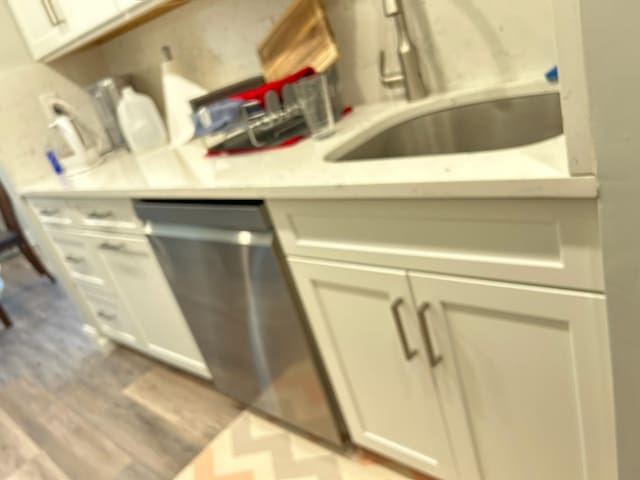 38 Tulip Ct, Nanuet, NY 10954 - kitchen featuring a sink, light countertops, light wood-style flooring, dishwasher, and white cabinets
