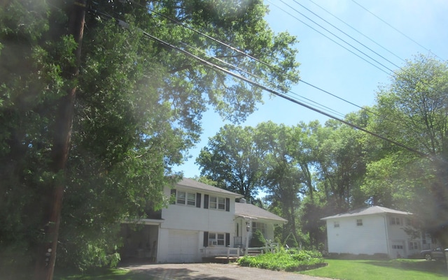 10 Lori St, Poughkeepsie, NY 12603 - view of front of house with a garage and a front lawn
