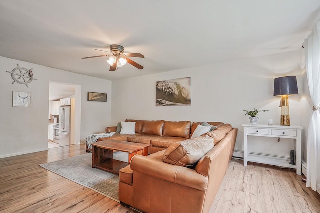 215 Lyman Rd, East Patchogue, NY 11772 - living area featuring ceiling fan, light wood-type flooring, baseboard heating, and baseboards