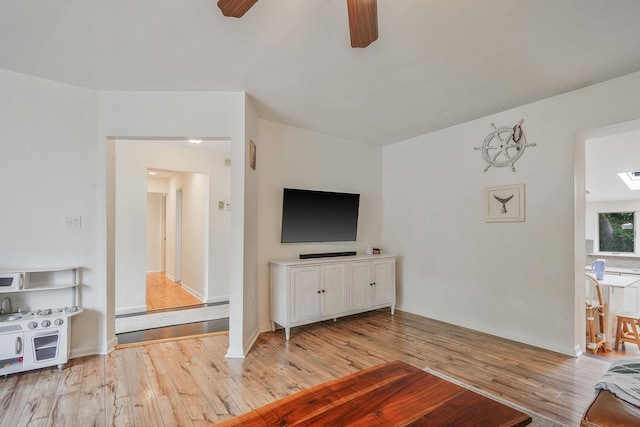 215 Lyman Rd, East Patchogue, NY 11772 - living area featuring a ceiling fan and light wood-style floors