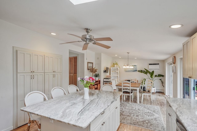 215 Lyman Rd, East Patchogue, NY 11772 - kitchen with light wood-style floors, a ceiling fan, dishwasher, recessed lighting, and a kitchen bar