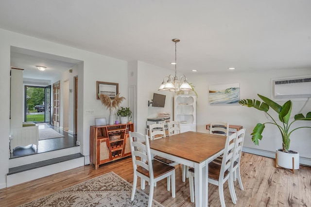 215 Lyman Rd, East Patchogue, NY 11772 - dining room with light wood-type flooring, a chandelier, a wall mounted AC, baseboard heating, and recessed lighting