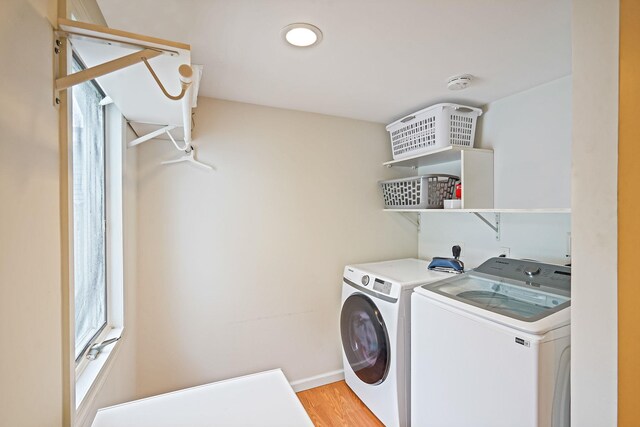 215 Lyman Rd, East Patchogue, NY 11772 - washroom featuring washing machine and dryer, light wood-type flooring, and baseboards