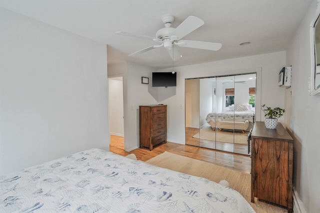 215 Lyman Rd, East Patchogue, NY 11772 - bedroom featuring light wood-style flooring, a closet, baseboard heating, and a ceiling fan