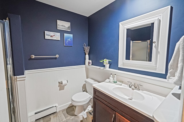 215 Lyman Rd, East Patchogue, NY 11772 - bathroom with a baseboard radiator, toilet, vanity, and wainscoting