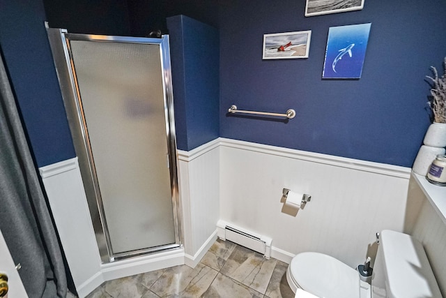 215 Lyman Rd, East Patchogue, NY 11772 - full bathroom featuring baseboard heating, a wainscoted wall, a stall shower, marble look tile flooring, and toilet