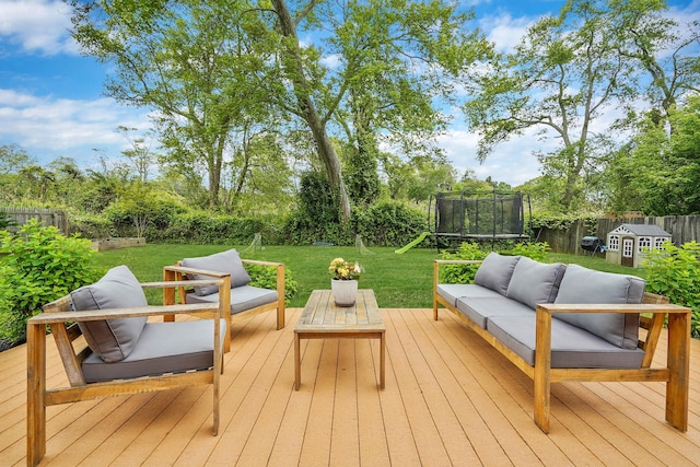 215 Lyman Rd, East Patchogue, NY 11772 - wooden deck featuring an outdoor hangout area, a trampoline, and view of scattered trees