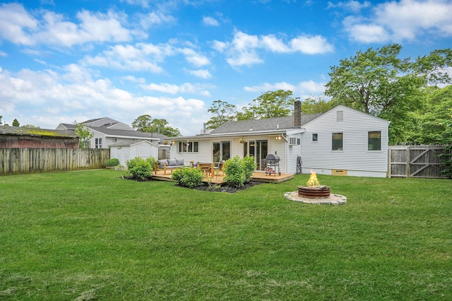 215 Lyman Rd, East Patchogue, NY 11772 - rear view of property featuring a fire pit, a wooden deck, and a chimney